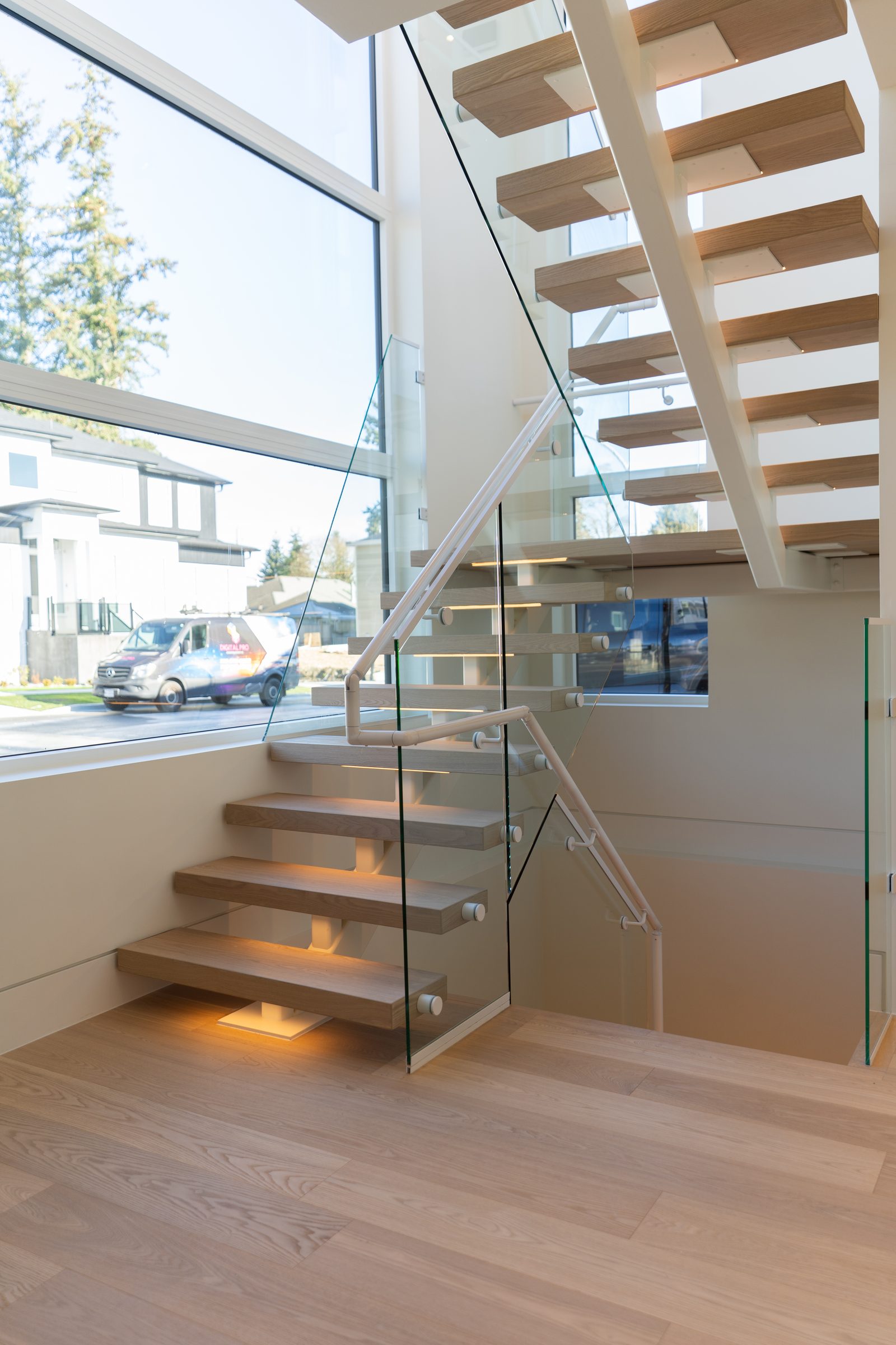Floating stair with glass guard in a BC Legacy custom home