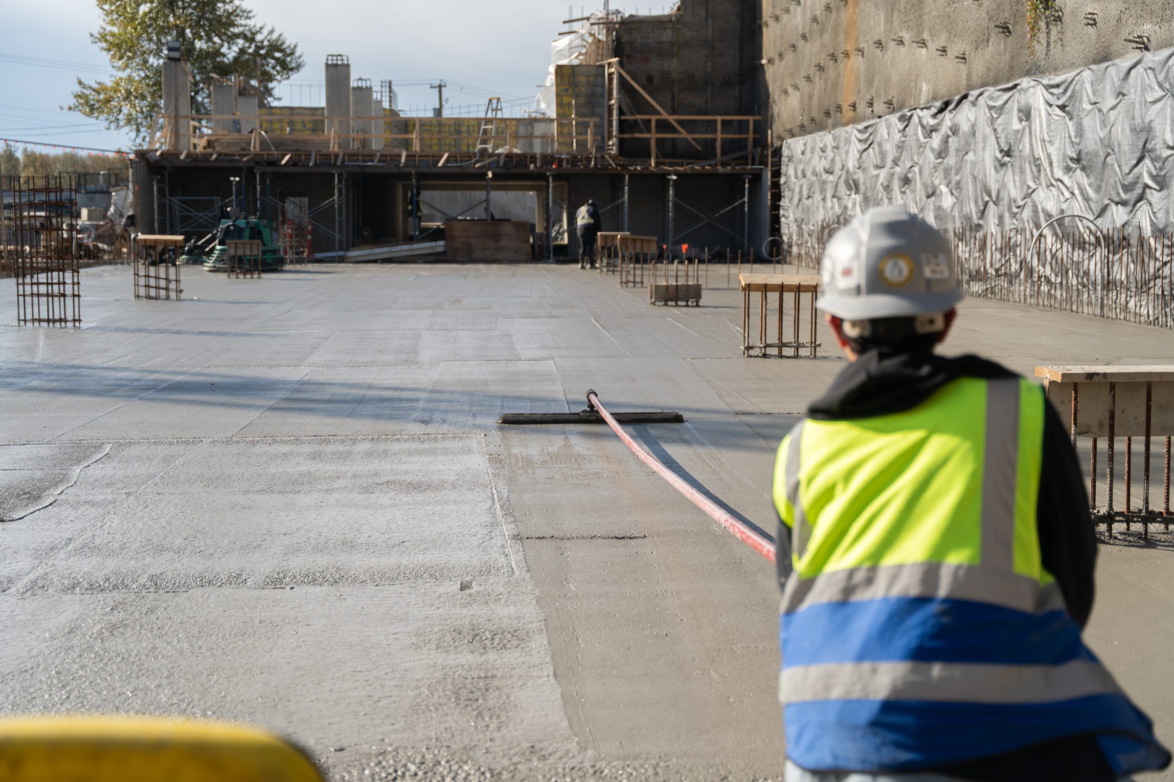 BC Legacy superintendent overseeing a concrete slab pour on a multi-family site